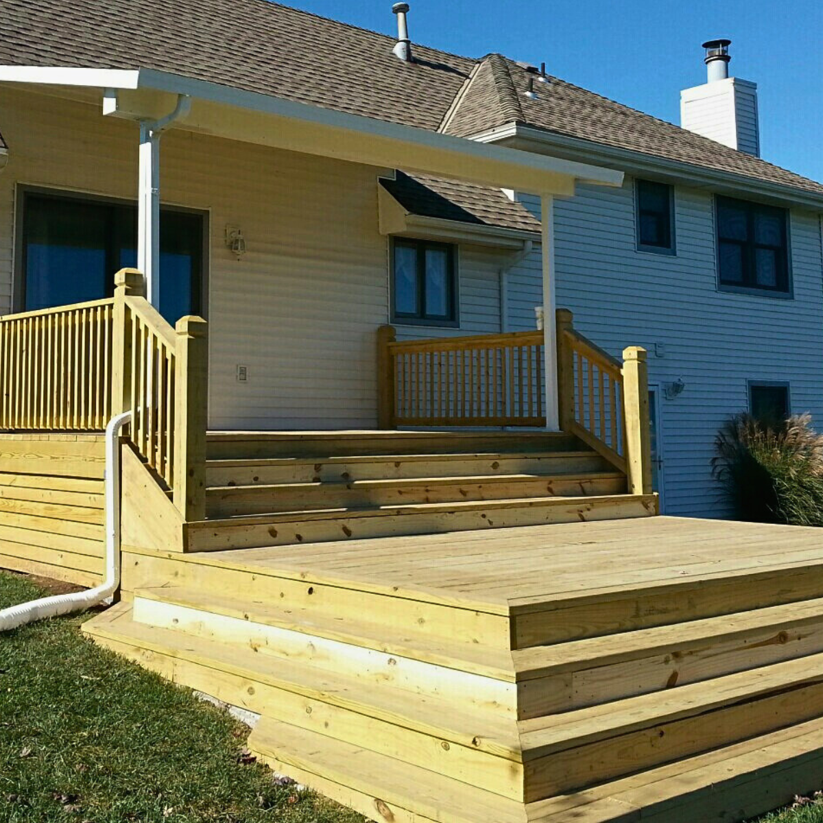 Custom Made ADDCO deck in pressure treated pine and cascading staircase. A Beautiful Addition to any yard.